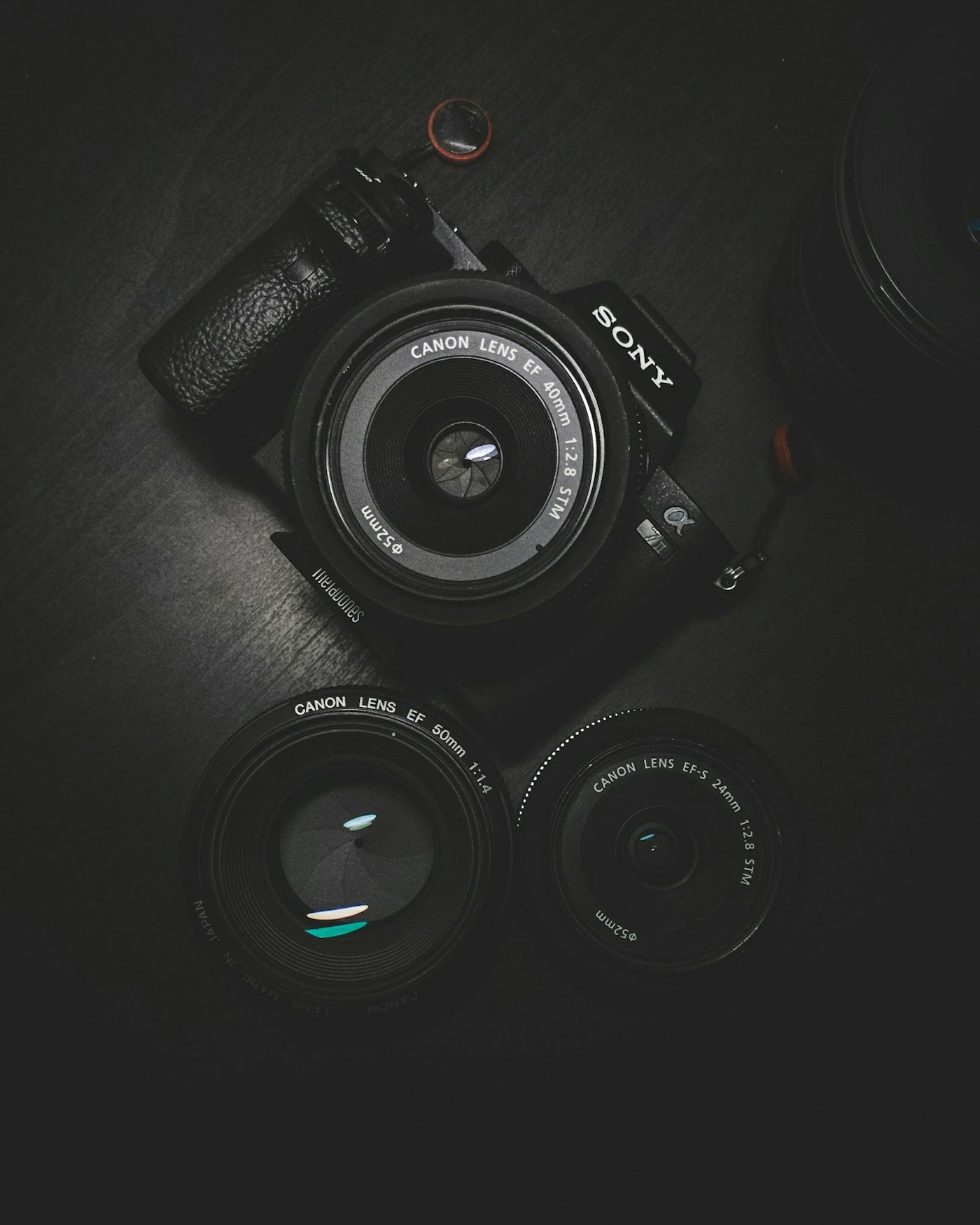 Film camera resting beside marked proof sheets on the editorial table